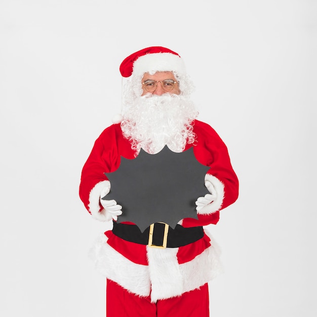 Santa Claus standing and holding blackboard