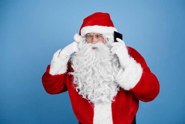 Santa claus talking by mobile phone