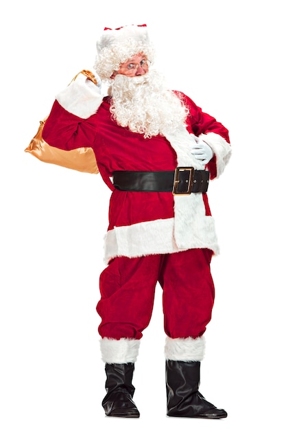 Free photo santa claus with a luxurious white beard, santa's hat and a red costume isolated on a white background with gifts