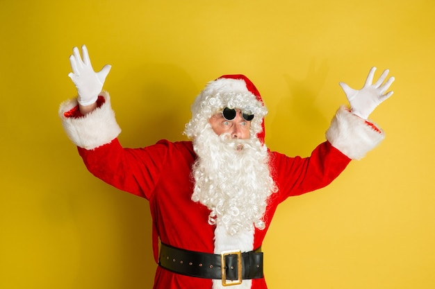 Free Photo santa claus with modern eyeglasses isolated on yellow