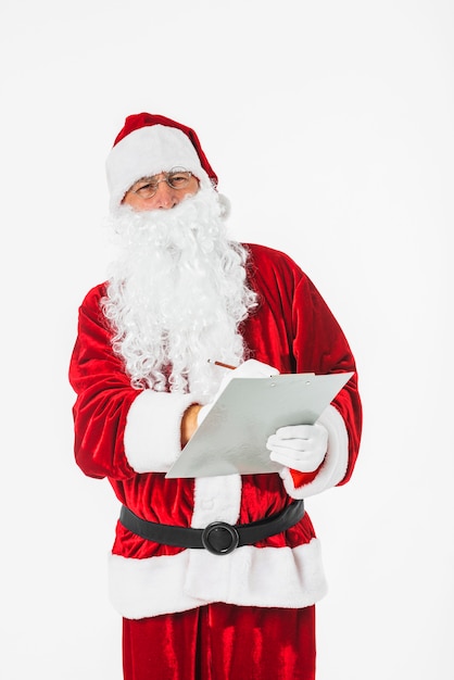 Free photo santa claus writing on paper with pencil