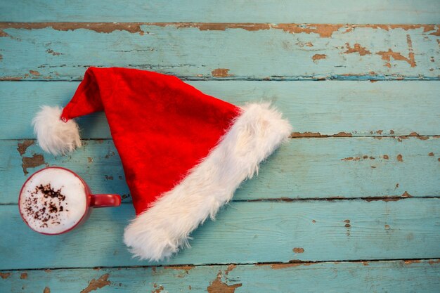 Santa hat on blue wooden boards