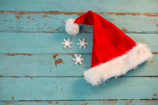 Free Photo santa hat on blue wooden boards