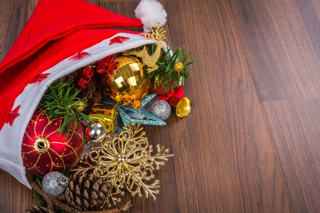 Santa Hat with Christmas decorations on wooden background