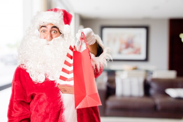 Santa with red purchase bags