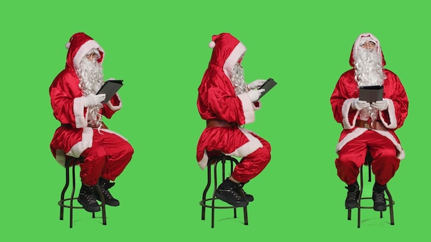 Free Photo santa working on digital tablet