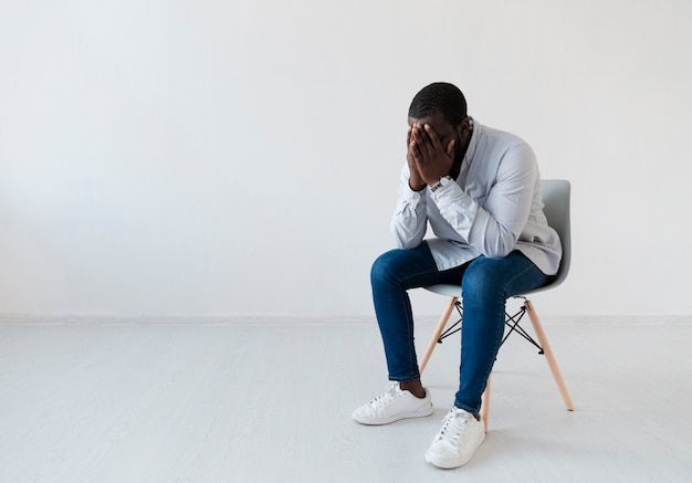 Sat afro american man sitting in a chair