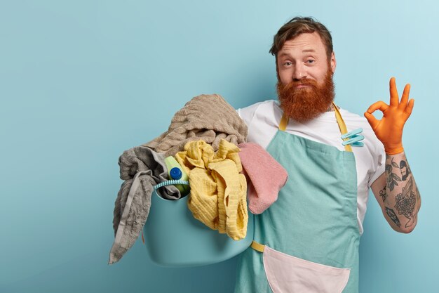 Free photo satisfied bearded red haired man makes okay gesture, shows approval sign, says everything is under control