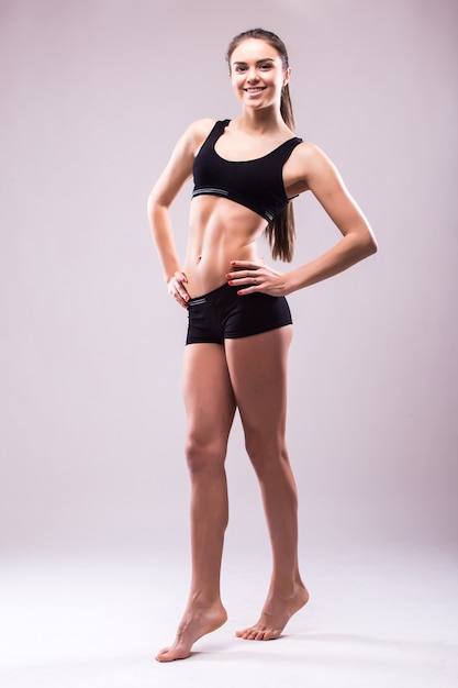 Satisfied confident active healthy woman in sports clothing with hands on hips