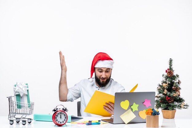 Satisfied proud young businessman in office celebrating and holding documents checking notes