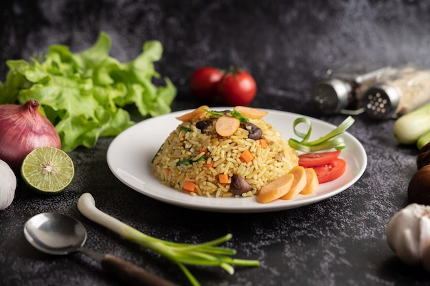 Free Photo sausage fried rice with tomatoes, carrots and shiitake mushrooms on the plate