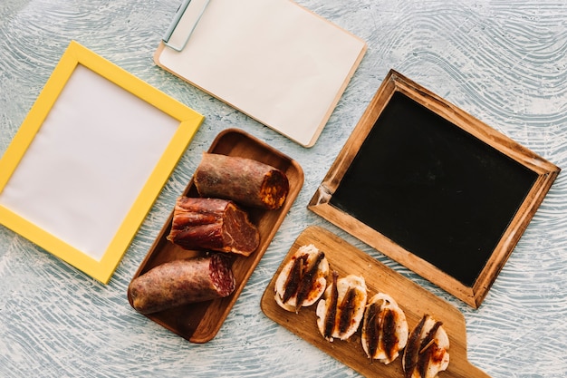 Sausages and sandwiches near empty surfaces