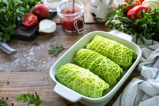 Savoy cabbage rolls stuffed with meat rice and vegetables on a rustic table