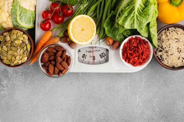 Scale with groceries on gray background