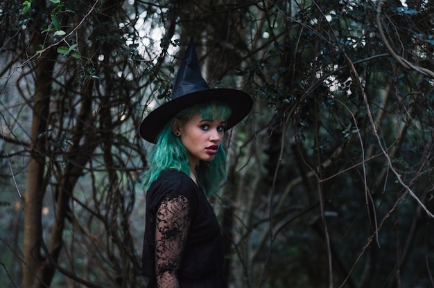 Free photo scared witch in misty forest