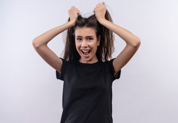 Free photo scared young caucasian girl wearing black t-shirt grabbed hair on isolated white background