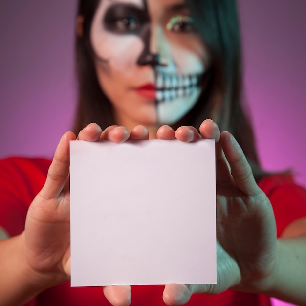 Scary girl showing square card