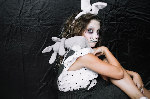 Free photo scary girl with rabbit making funny face