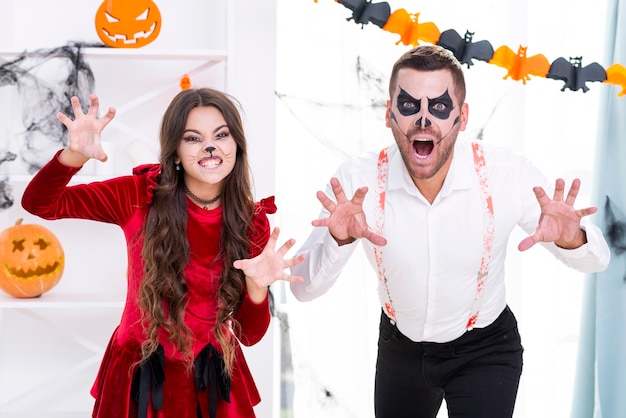 Scary man and young girl in halloween costumes