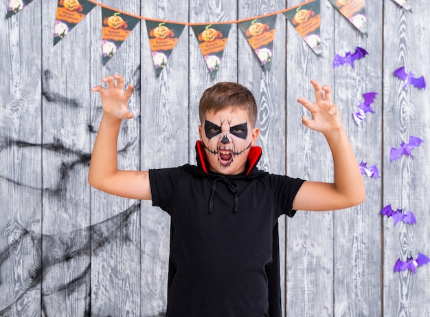 Free Photo scary young boy with face painted for halloween