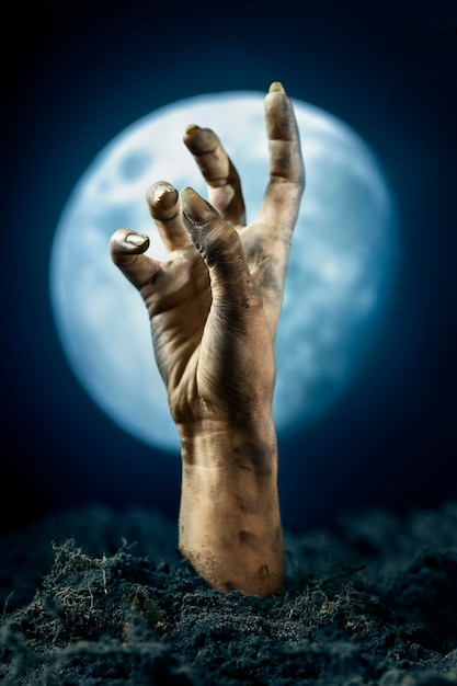 Free Photo scary zombie hand from the ground at night