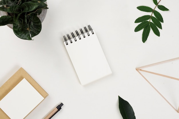 Scattered office supplies and leaves on table