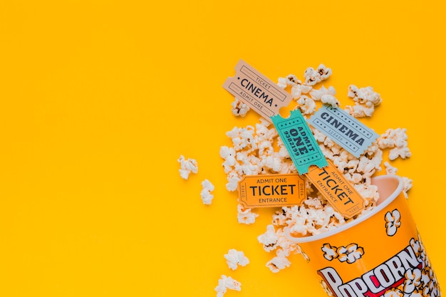 Scattered popcorn box with cinema tickets