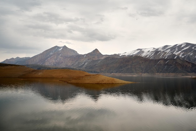 Scenic view of the Azat reservoir in Armenia with a snow-capped mountain range in the background