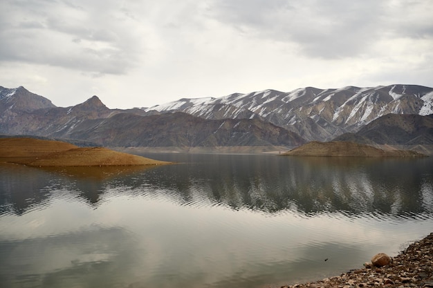 Scenic view of the Azat reservoir in Armenia with a snow-capped mountain range in the background