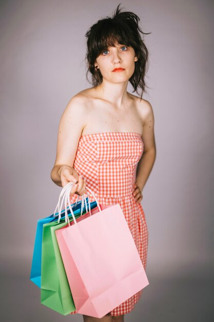 Sceptic woman with paper bags