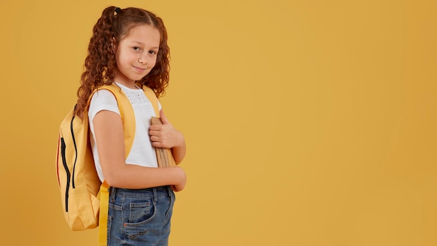 School girl standing side view copy space