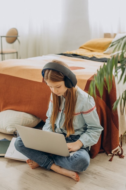 School girl studying at home, distant learning