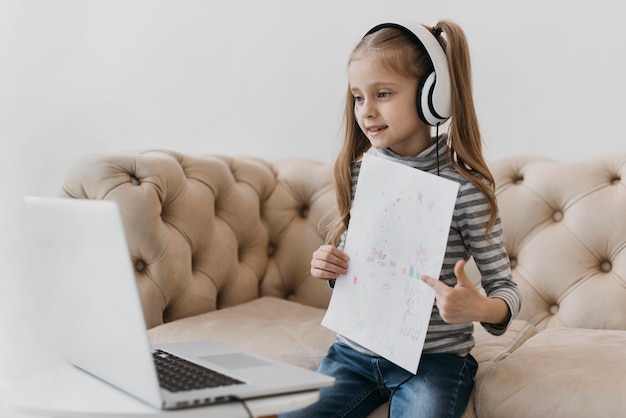 School girl wearing headphones virtual courses