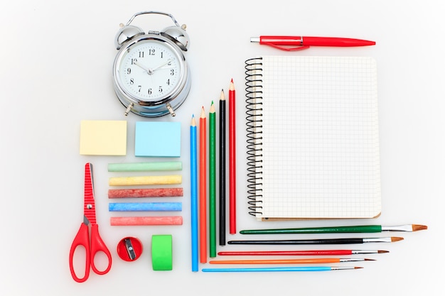 Free photo school set with notebooks, pencils, brush, scissors and apple on white