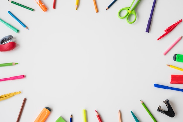 School supplies arranged in circular shape over the white background