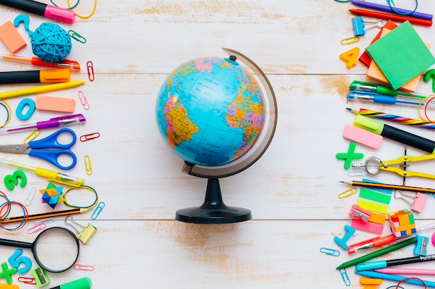 School supplies with copy space in the middle on wooden background