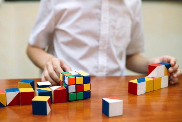 Free Photo schoolboy at desk with puzzles