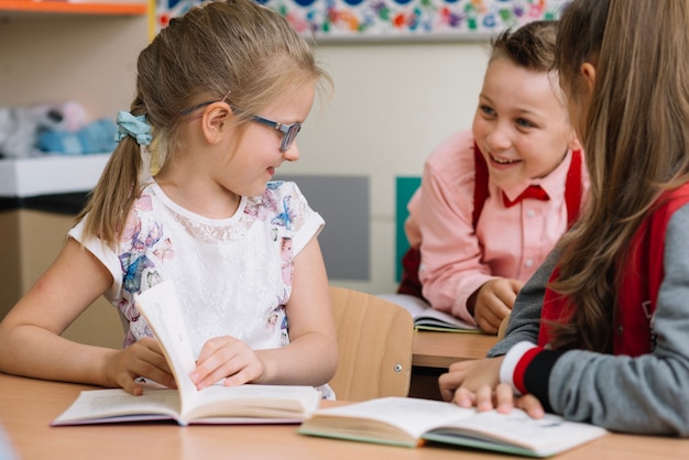 Schoolchildren sitting in classroom talking