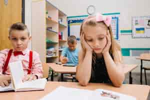 Free photo schoolchildren studying in classroom reading