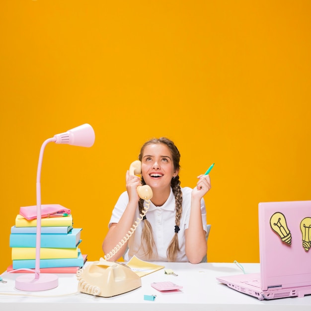 Schoolgirl on desk with laptop in memphis style