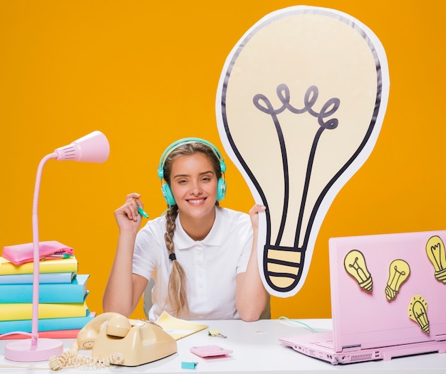 Schoolgirl on desk with laptop in memphis style