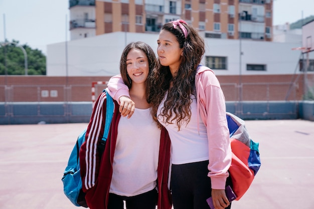 Schoolgirl friends in schoolyard