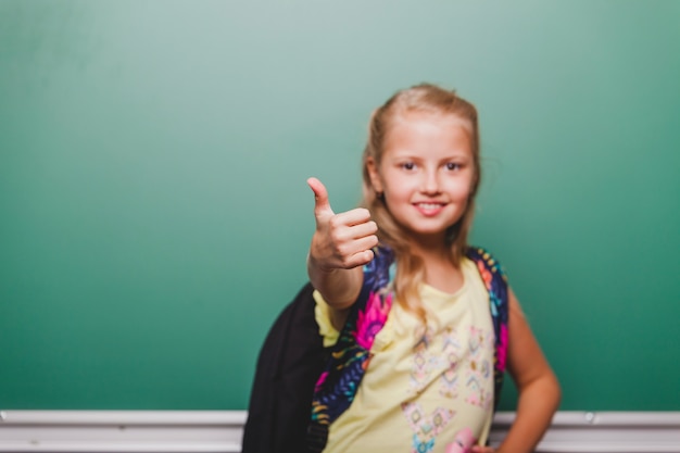 Free photo schoolgirl gesturing thumb up