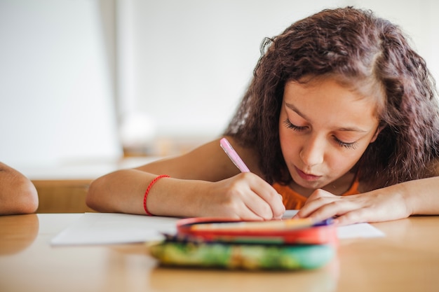 Free Photo schoolgirl holding pen drawing