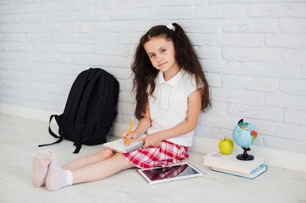 Schoolgirl sitting with notepad