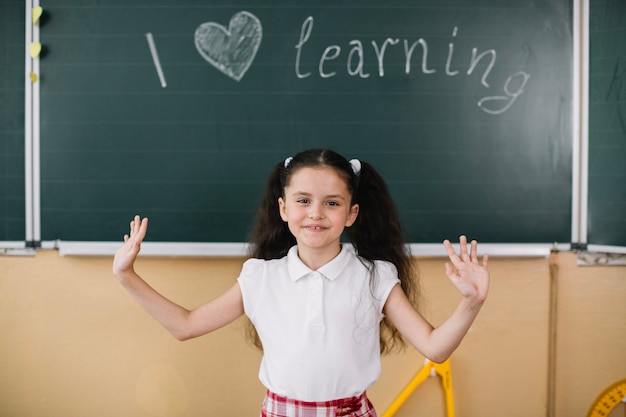 Free photo schoolkid at blackboard in class