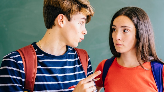 Schoolkid explaining something to his friend