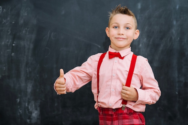 Free photo schoolkid showing thumb up gesture