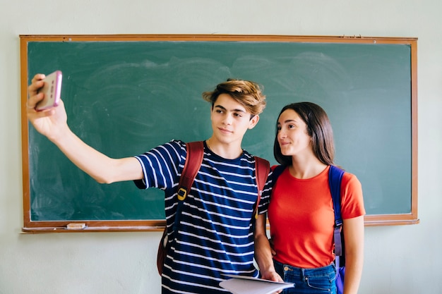 Schoolkids taking selfie in classroom