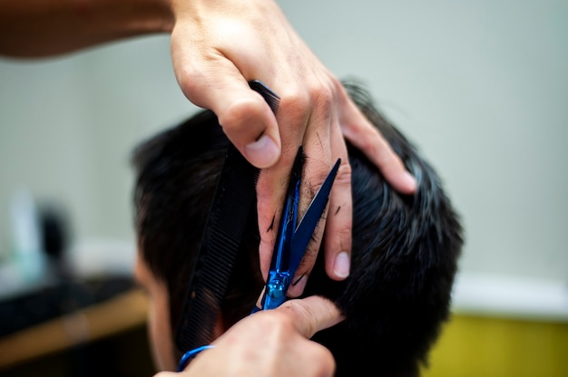 Scissors and hands on customer hair